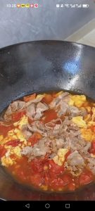 Slide the blanched beef into the wok and pour in the hot water so everything is just barely covered.