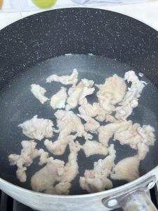 Bring water to a boil, then turn off the heat and slide in the pork slices one at a time.
