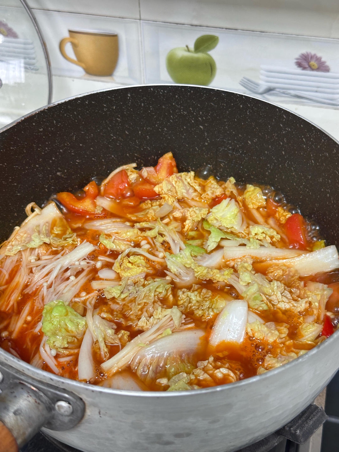 Add the enoki mushrooms and napa cabbage and simmer for 3 minutes.