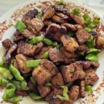 Twice-cooked pork huiguorou with crisp green peppers in a wok