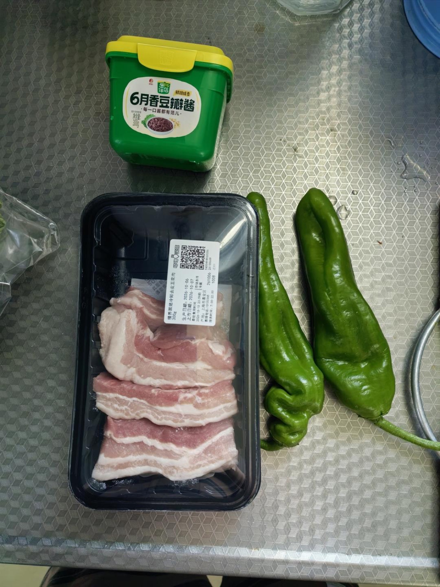 Set out the doubanjiang, the pork belly, and the green peppers so everything is ready before you turn on the heat.