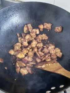 Add the minced garlic, soy sauce, doubanjiang, and sugar, and stir until the meat is evenly coated and glossy.