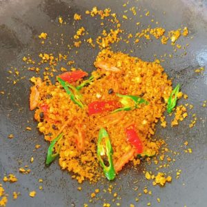 Add the green and red chilies to the pan.