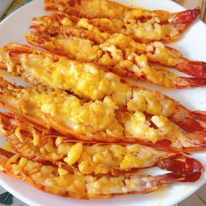 Add a generous amount of cooking oil to a flat-bottom pan, lay the prawns in and sear both sides until lightly golden and just cooked through.