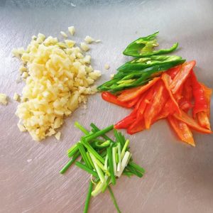 Prepare the minced garlic, green and red chilies, and scallion segments.