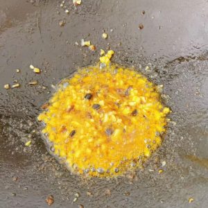 Add the minced garlic and fry over low heat until fragrant. Don't cook it too long — overcooked garlic turns bitter and ruins the taste.