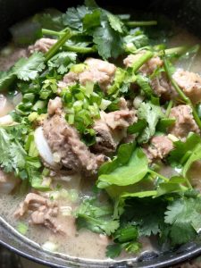 Turn off the heat, scatter the celery, scallion, and cilantro over the top, stir everything together, and it is ready to come out of the pot.