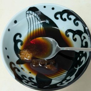 Whisk the grated garlic, miso, sugar, soy sauce, and sake together in a small bowl until the miso dissolves and the sugar is fully incorporated.