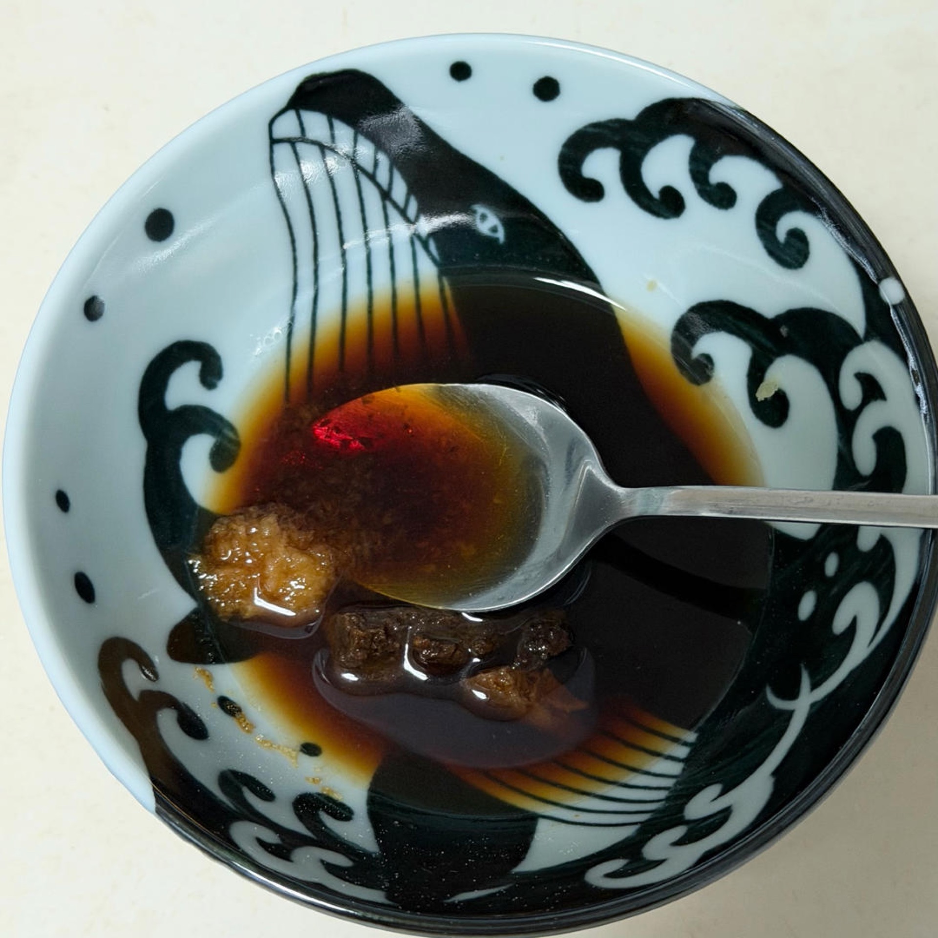 Whisk the grated garlic, miso, sugar, soy sauce, and sake together in a small bowl until the miso dissolves and the sugar is fully incorporated.