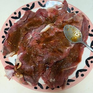 Lay the beef slices flat and brush or spread the marinade evenly over both sides; thin slices only need about 5 minutes to absorb the flavor.