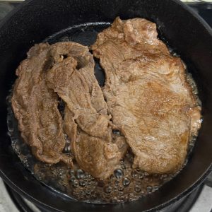 Spray a frying pan with oil over medium heat, add the marinated slices, and flip once the first side changes color, cooking just a few more seconds on the second side since the mar