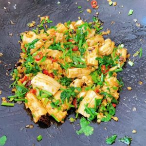 Just before removing from the heat, add the chopped cilantro and scallions, season with salt and MSG, and toss until evenly coated.